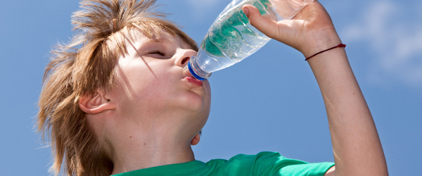 A boy drinking bottled water