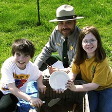 (photo) NPS ranger and kids practice archeology. (NPS)