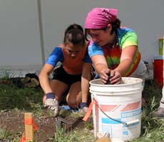 (photo) Two girls work together on an excavation. (NPS)