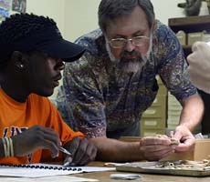 (photo) Collections specialist and student discuss artifacts. (New Philadelphia)
