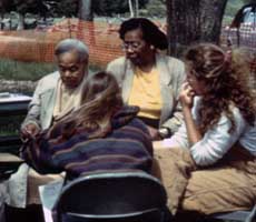 (photo) Archeologists talk to members of the Robinson family. (University of Maryland)