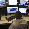 Picture of man at a set of computer screens. 
