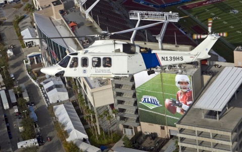 A CBP helicopter patrols over Superbowl XLIII