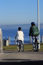 Photograph of two women riding bikes