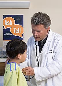 A doctor looks at a child patient.