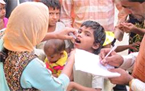 Health care worker examining a child