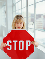 A woman holding up a stop sign