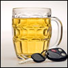 A car key next to a glass of beer