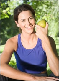 A woman holds an apple
