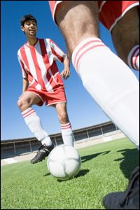 Two men playing soccer