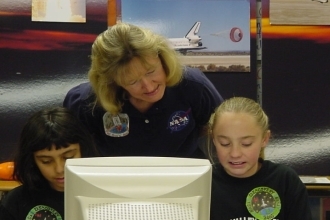NASA volunteer Sonja Wood teaches local school children.