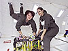 Two students float during a reduced gravity flight