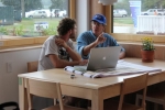 Matt Hansen reviews each team’s design drawings and construction specifications to estimate the total construction cost of its house. (Credit: Alexis Power/U.S. Department of Energy Solar Decathlon)