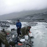 USGS scientists Doug Halm, Paul Schuster, and Kathy Kelsey collecting melt water samples from Gulkana Glacier.