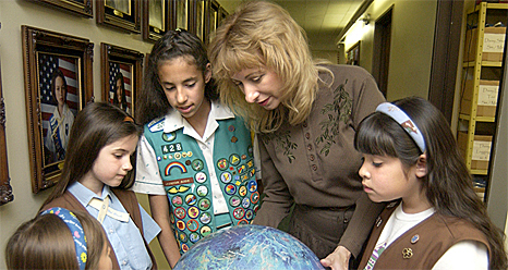 Woman showing girls a globe of Venus