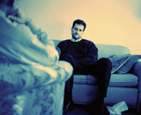 Photo of male sitting on a couch