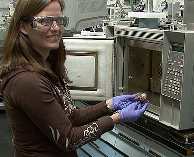 Tara Lovestead prepares a sample of meat (by excising a few milligrams) for testing with a new sampling method developed by NIST researcher Tom Bruno that can detect trace amounts of low volatility compounds produced when perishable foods such as chicken begins to spoil.