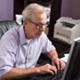 Photo: A man working at a computer