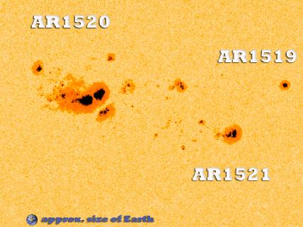 Large sunspot region 1520 with AR1519 and AR1521 with Earth to scale for comparison.