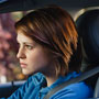 Teenage girl at steering wheel