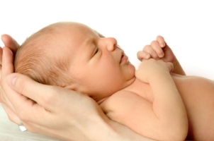 Newborn in adult hands