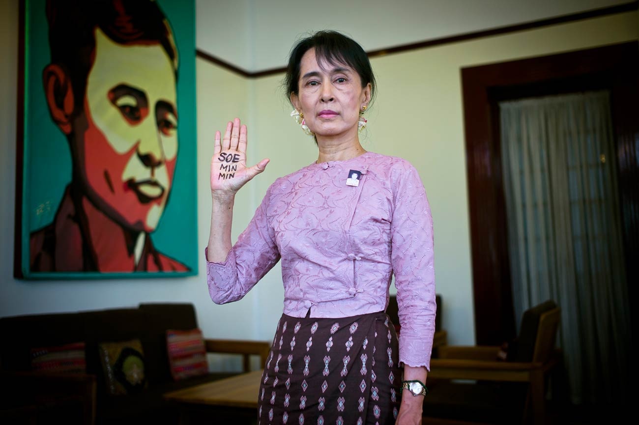 Aung San Suu Kyi raising hand with writing on it