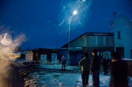 People standing outside at night time.