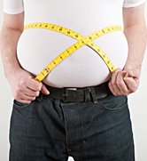 A man measures his rather large belly