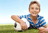 A young boy and a soccer ball.