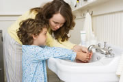 Photo of mother and child washing hands together