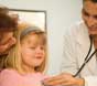 Doctor examining a little girl.