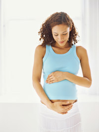 Photo: Pregnant woman cradling stomach