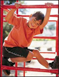 photo of child on playground equipment