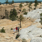 Hikers cross the mesa top on the Headland Trail.