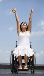 girl with outstreched arms in a wheelchair