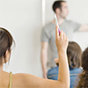 student raising hand in classroom