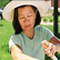 woman spraying tick repellant on her arm