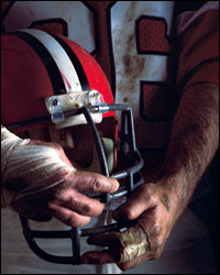 Photo: A football player holding his helmet