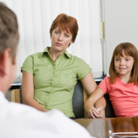 Photo: Mother and daughter talking with a healthcare professional.