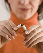 Woman breaking cigarette.