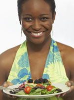 Woman with a plate of fruits and vegetables.