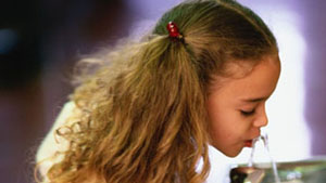 Girl drinking from fountain