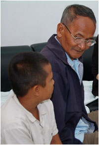 A grandfather and his HIV-infected grandson receive counseling at Bangkok’s Siriraj Hospital, which uses a new model of pediatric HIV counseling.