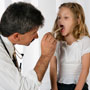 Photo: Doctor examining young girl's throat