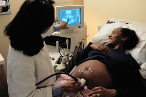 woman getting an ultrasound done by a doctor