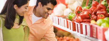 Photo: Young couple selecting produce