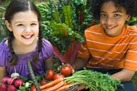 Photo: boy and girl holding fresh produce