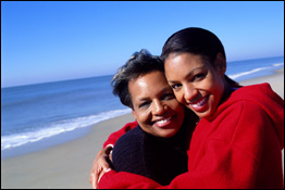 two women hugging at the beach