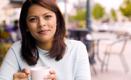 Hispanic Woman holding coffee mug