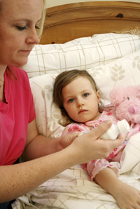 Mother takes care of little girl.